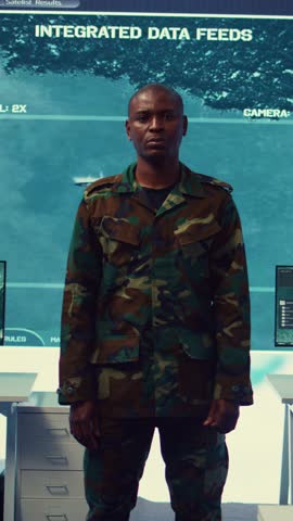 Vertical Video Portrait of confident military general wearing camo uniform in mission control center, overseeing operations regarding the national safety and protocol. Federal army base command post