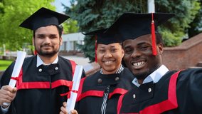 Portrait of a group of students taking selfies on graduation day - Powered by Shutterstock - Get 15% off with code: PIKWIZARD15