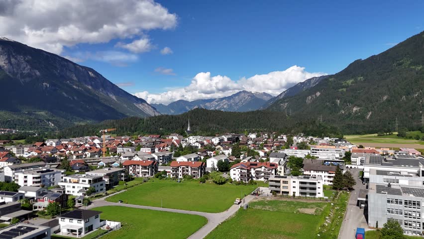 Bonaduz, switzerland with picturesque mountains and bright blue sky, aerial view