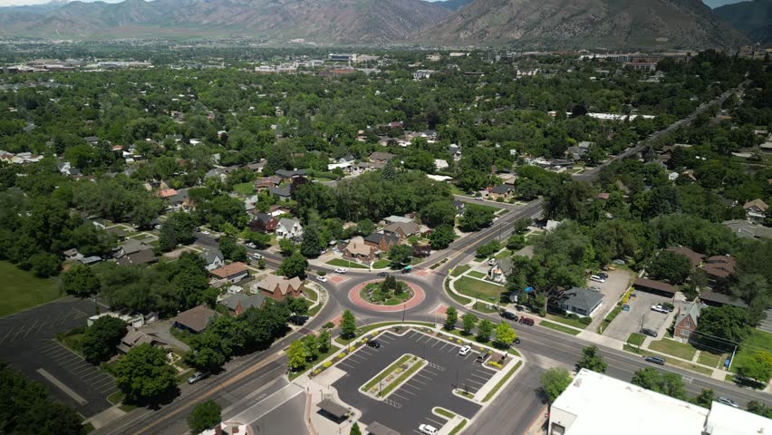 Aerial of round a bout in town of Logan Utah in spring time