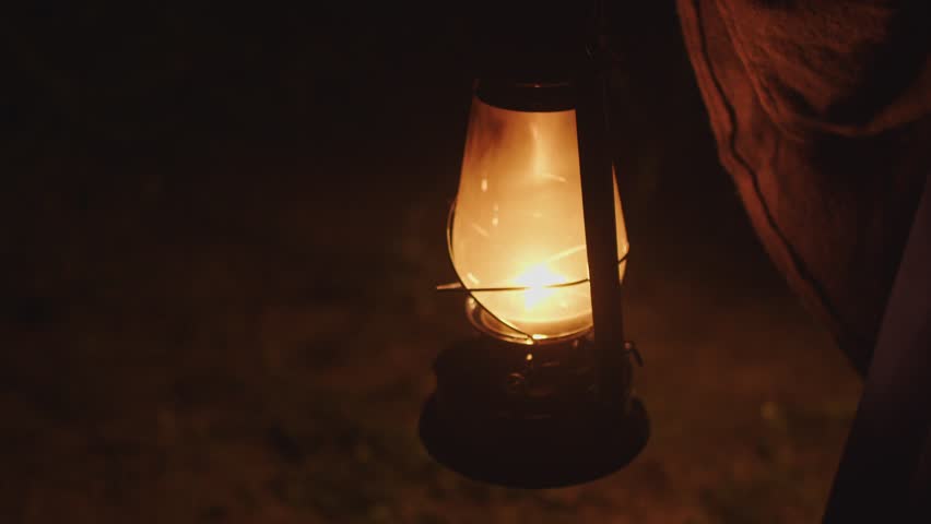 The kerosene lamp burns in the dark and sways