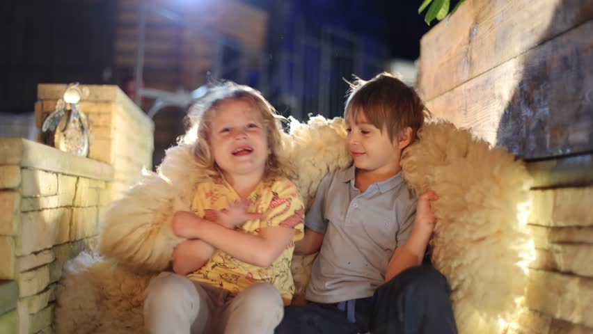Happy children oudoors at night, having fun laughing and enjoying warm spring night	