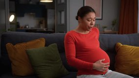 African American woman female pregnant girl at home pregnancy lady future mother unhappy feeling bad belly ache pain painful cramps start of contractions medicine problem childbirth health trouble - Powered by Shutterstock - Get 15% off with code: PIKWIZARD15