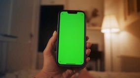 Young girl using smartphone with green screen lying on the bed while chatting with friends, reading ebook, surfing in social media. - Powered by Shutterstock - Get 15% off with code: PIKWIZARD15