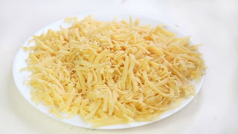 Falling pieces of grated cheese for pizza
