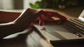 Close-up of Hand on Laptop Touchpad in Sunlit Room - Powered by Shutterstock - Get 15% off with code: PIKWIZARD15