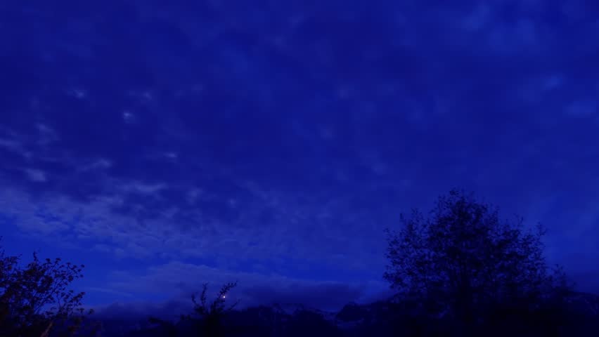 Night starry star with bright moon light on cloudy sky n fast moving stormy dark cloud n cloudscape over Switzerland snow alps mountain n pine forest in spring or winter, Stop motion 4k TimeLapse