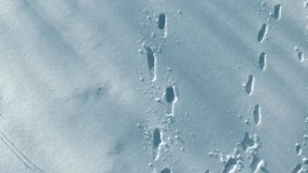 Footprints in the snow create a path across a pristine winter landscape - Powered by Shutterstock - Get 15% off with code: PIKWIZARD15
