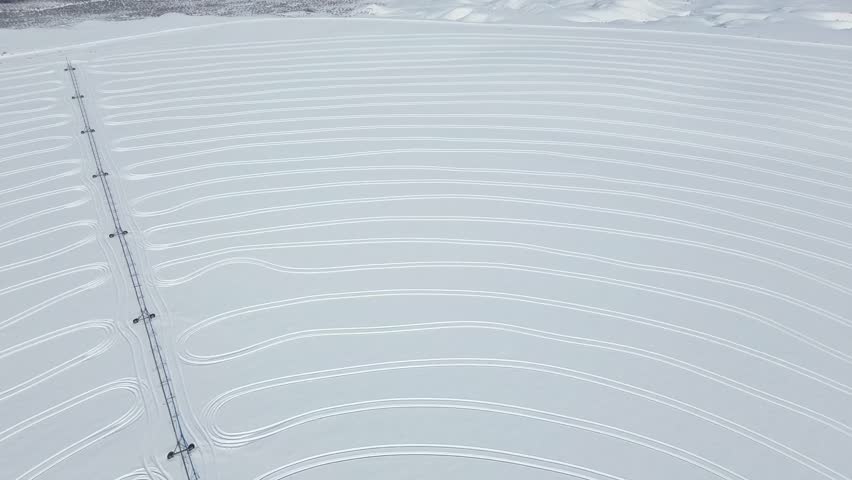 An aerial footage of circle tracks on the snow for industrial purposes