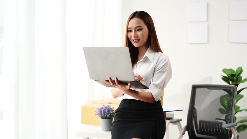 : A woman is sitting on the floor in front of a couch and boxes