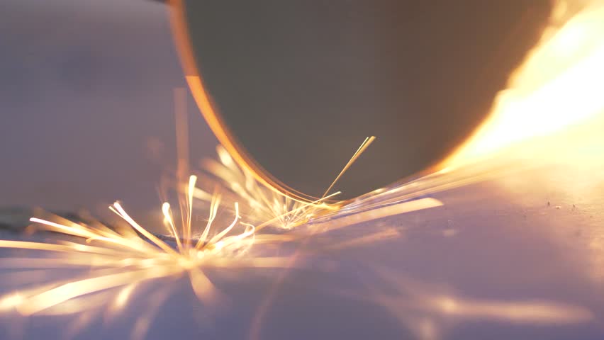 Worker cutting steel with cutting wheel saw, Sparks coming out of steel cutting machine