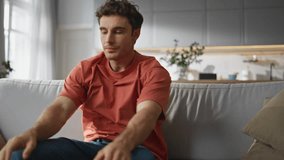 Tired man falling on coach feeling exhausted closeup. Sleepy freelancer opening laptop returning to work at living room. Weary handsome guy sitting sofa using computer at cozy home interior alone - Powered by Shutterstock - Get 15% off with code: PIKWIZARD15