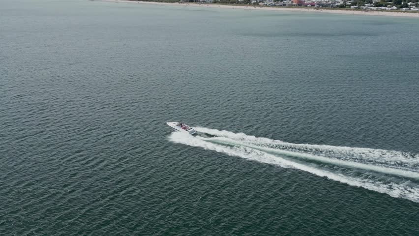 The drone view of the white boat driving in the water, Fehmarn island, Germany, aerial