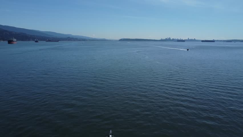 An aerial shot of boats flushing in the deep blue sea at the port of Lighthouse park Vancouver, British Columbia, Canada
