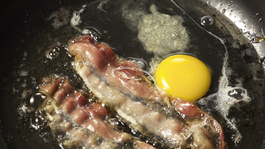 Frying Pan with Bacon and Eggs on colorfull background