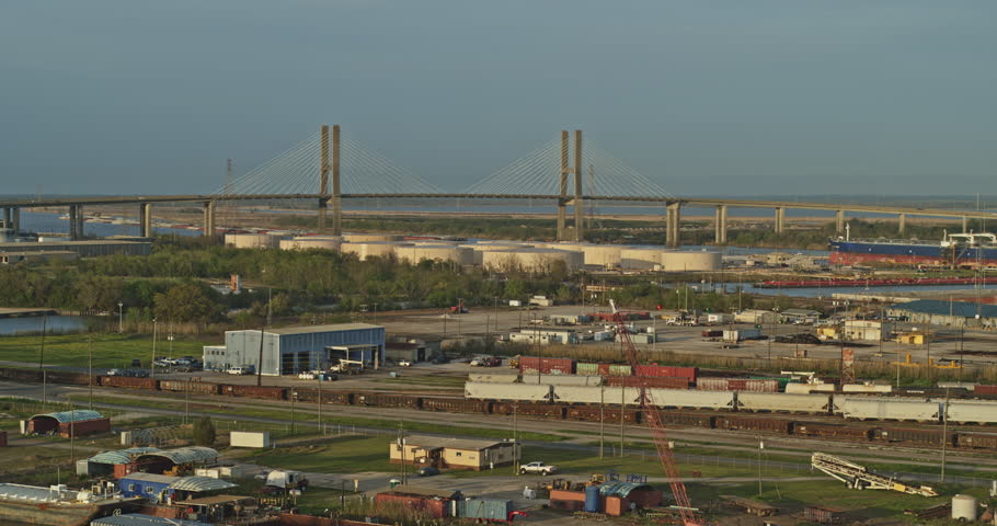 Mobile Alabama Aerial v10 Flying low over industrial trainyard area with cityscape views at sunset - March 2020