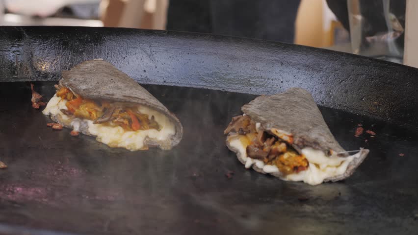 Mexican Street Food Traditional Gorditas Preparation with Cheese and Meat tacos, delicious savory meal