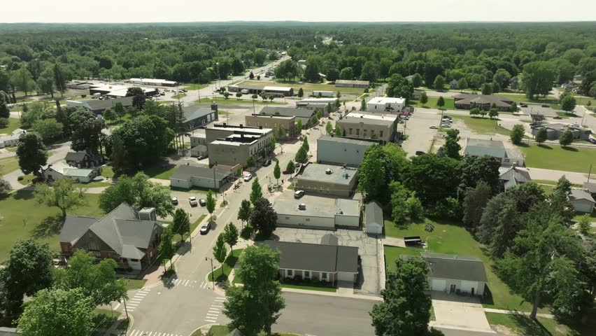 Howard City, Michigan downtown with drone video moving in at an angle.