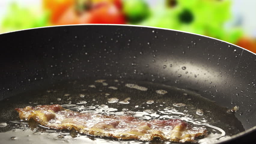 Frying Pan with Bacon and Eggs on colorfull background