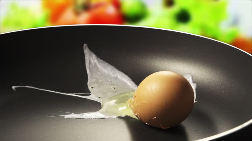 Raw egg falls on the pan