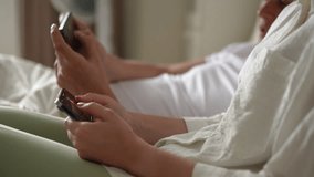 Cropped shot of young couple together quickly clicking fingers smartphones screen to farming new popular Hamster Kombat cryptocurrency in mobile phone online application, sitting on sofa, slow motion. - Powered by Shutterstock - Get 15% off with code: PIKWIZARD15