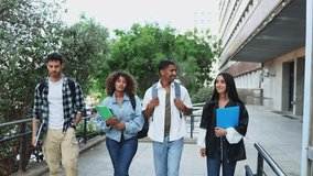 Cheerful young multiethnic university students in stylish clothes interacting and strolling on pavement with backpacks and notebooks after classes on campus against trees 
 - Powered by Shutterstock - Get 15% off with code: PIKWIZARD15