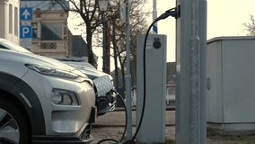 EV charging an electric car. Power supply for electric car charging. Electric car battery charger. EV car charging station. Clean energy, Green eco concept. Charging cable connected - Powered by Shutterstock - Get 15% off with code: PIKWIZARD15