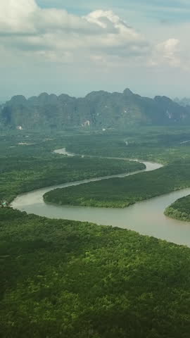 Aerial view of the Phang Nga bay with mangrove tree forest and hills in the Andaman sea, Thailand. Vertical video