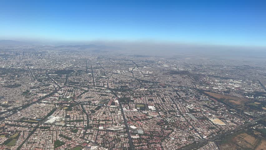 Flying in airplane over Mexico City Volcanoes Mountains City and desert. High quality 4k footage