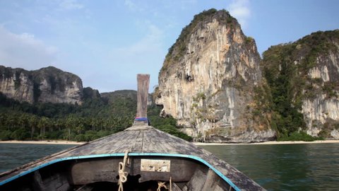 Thai boat - longtail floats to a beach