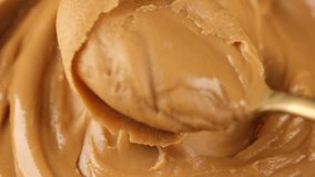 Eating peanut butter. Mix with spoon peanut butter, close up - Powered by Shutterstock - Get 15% off with code: PIKWIZARD15