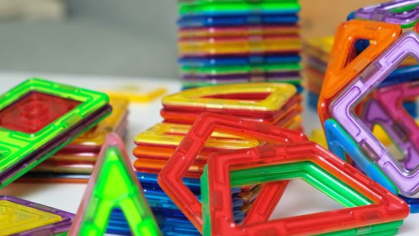 A set of magnetic constructor parts, squares, triangles and other figures for games for children