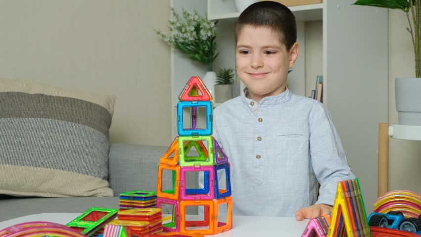 Boy building a tower from a magnetic construction set, slow motion - Powered by Shutterstock - Get 15% off with code: PIKWIZARD15