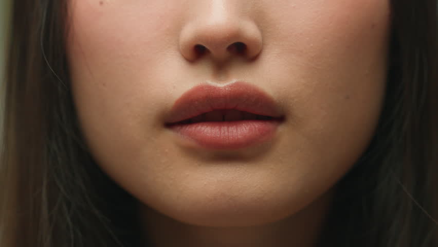 Silence gesture extreme close up female mouth Asian chinese korean japanese woman unrecognizable lady girl hush lips keep secret silent whisper quite secrecy confidential mysterious model face details