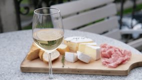 a woman's hand takes a white wine glass from the table. - Powered by Shutterstock - Get 15% off with code: PIKWIZARD15