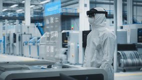 Steryle Coverall Wearing Engineer Uses Augmented Reality Headset to Interact With Complex 3D Holographic Model of Silicon Microchip in Manufacturing Facility, Precision Engineering of PC Hardware - Powered by Shutterstock - Get 15% off with code: PIKWIZARD15