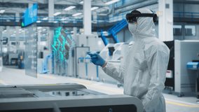Steryle Coverall Wearing Engineer Uses Augmented Reality Headset to Interact With Complex 3D Holographic Model of Silicon Microchip in Manufacturing Facility, Precision Engineering of PC Hardware - Powered by Shutterstock - Get 15% off with code: PIKWIZARD15