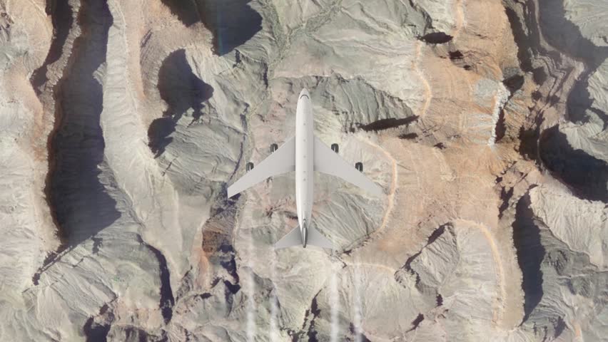 Airplane flying over the alps. Passenger or cargo airliner flies high above mountains