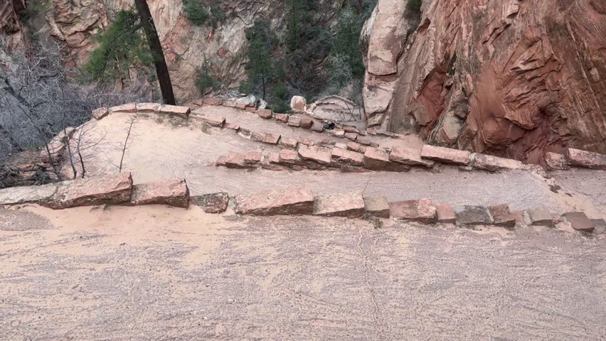 Timelapse of a female hiker with a backpack hiking up the winding and steep Walter