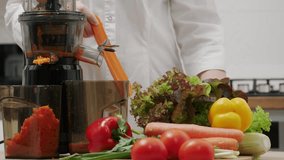 A woman prepares carrot juice using a juicer at home in the kitchen. - Powered by Shutterstock - Get 15% off with code: PIKWIZARD15