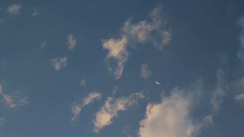 Clouds Drift Across a Crescent Moon