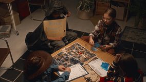 Top view of multiethnic children in costumes gathered at home in evening for role playing game. Girl distributing cards to players - Powered by Shutterstock - Get 15% off with code: PIKWIZARD15