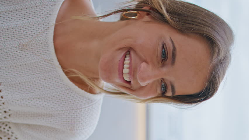 Smiling lady relaxing cafeteria vertical view closeup. Happy blonde woman holding espresso cup enjoying cafe date. Unrecognizable boyfriend feeding girlfriend with dessert at marine view restaurant