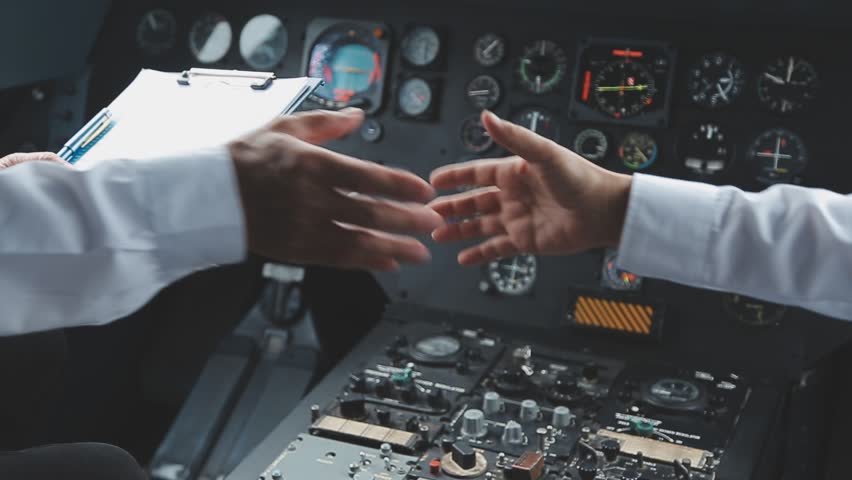 Professional pilot woman in uniform has teamwork meeting for success flight in aviation business. Young female captain instructor sitting in office and working or training commercial airline crew.