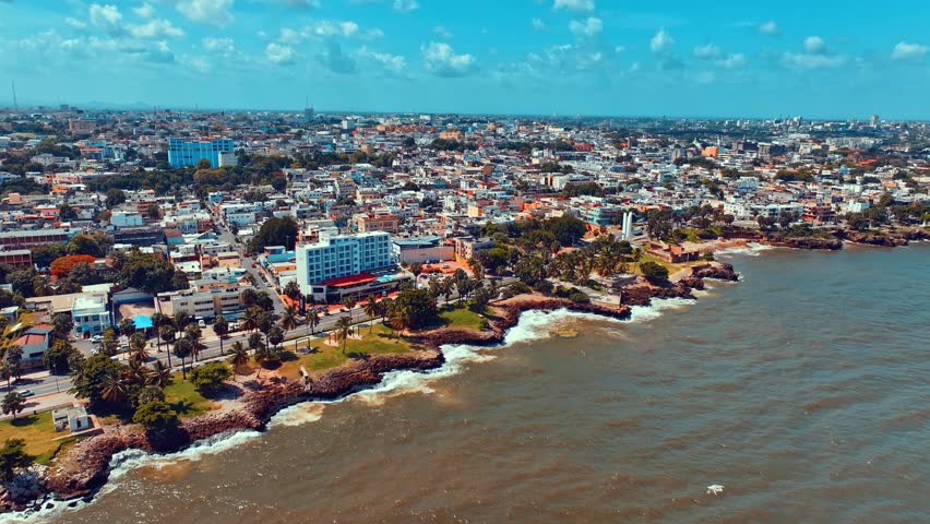 Aerial view of the beautiful capital of Central America. City skyline of Santo Domingo. City and sea 4k background. Travel and vacation concept. Panorama of the city landscape during the day.