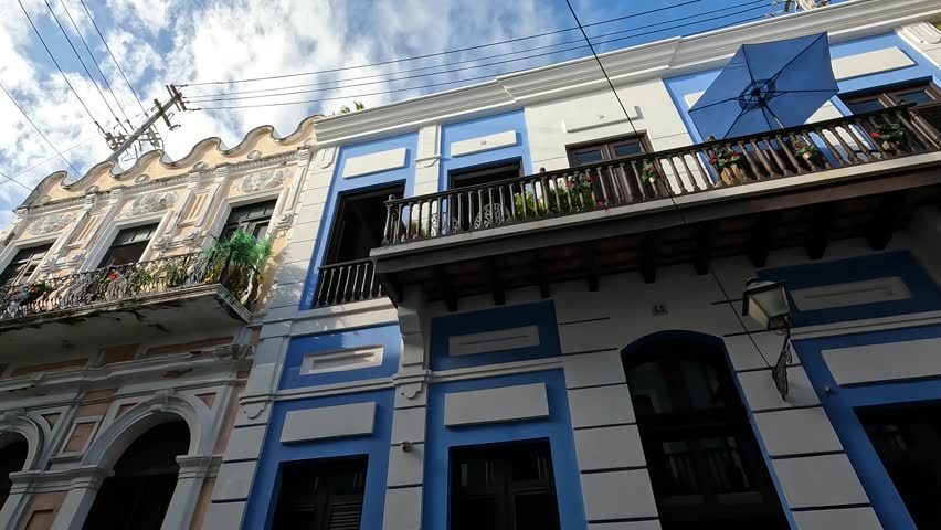 walking down street in old san juan puerto rico (beautiful cobblestone alley path with colorful colonial historic spanish homes) buildings downtown caribbean island travel tourism destination getaway