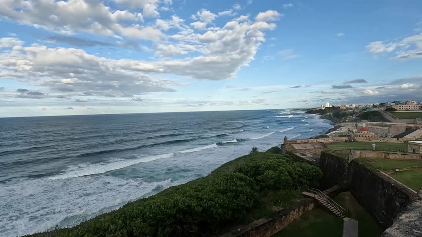 view of waves crashing on the shoreline from castillo san felipe del morro in old san juan puerto rico (tropical island beach coast) historic fort castle travel tourism national park destination trip
