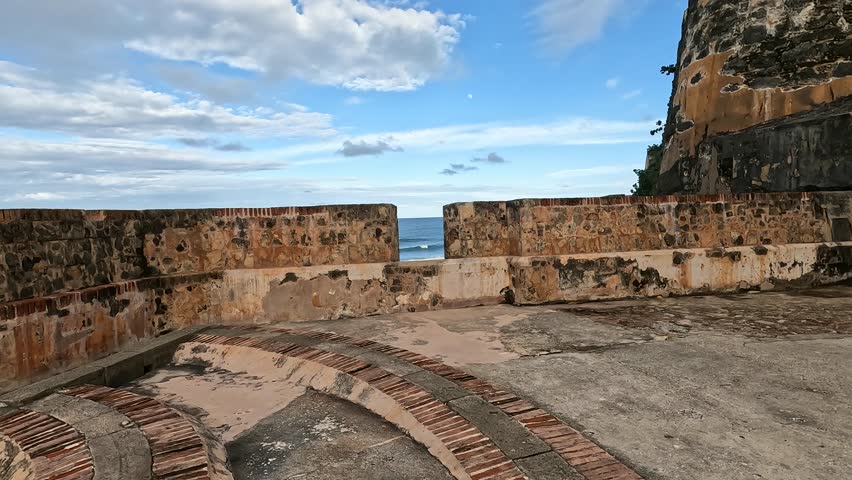 view of waves crashing on the shoreline from castillo san felipe del morro in old san juan puerto rico (tropical island beach coast) historic fort castle travel tourism national park destination trip