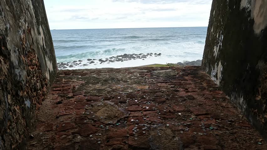 view of waves crashing on the shoreline from castillo san felipe del morro in old san juan puerto rico (tropical island beach coast) historic fort castle travel tourism national park destination trip