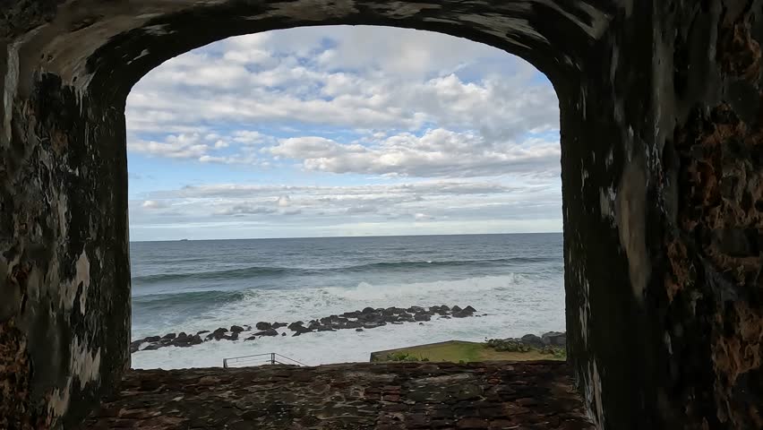view of waves crashing on the shoreline from castillo san felipe del morro in old san juan puerto rico (tropical island beach coast) historic fort castle travel tourism national park destination trip